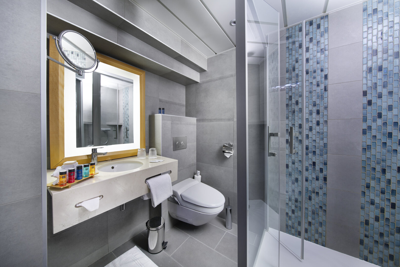 Modern bathroom with blue tile shower and minimalist design